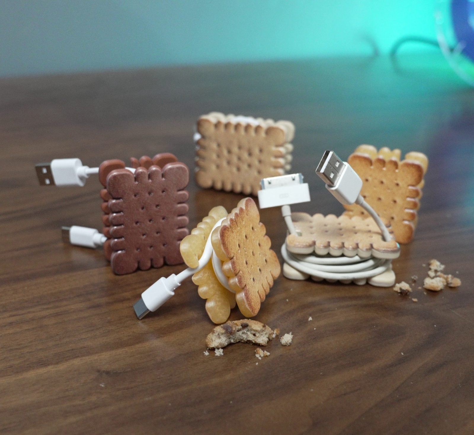 Biscuit-shaped cable organizers holding USB cables.
